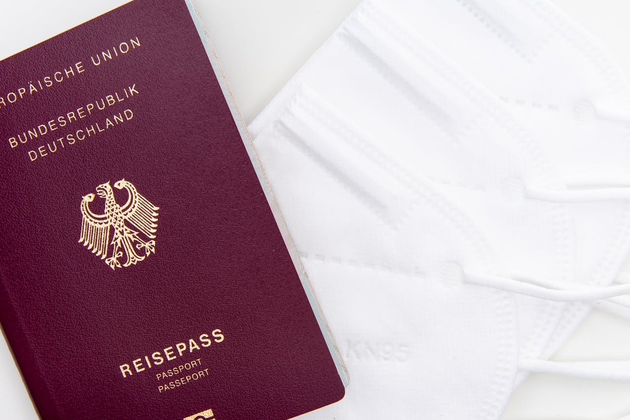 services-02 Close-up of a German passport and KN95 masks symbolizing travel during the pandemic.